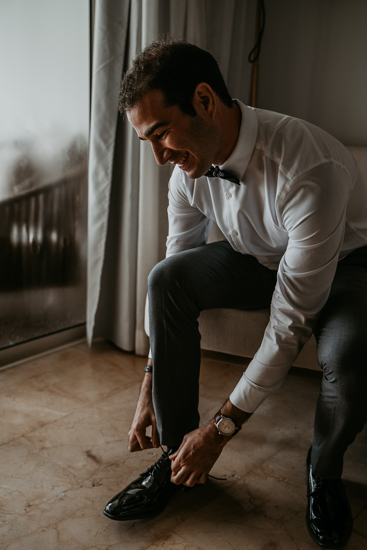 Persian wedding in Puerto Rico groom putting on shoes