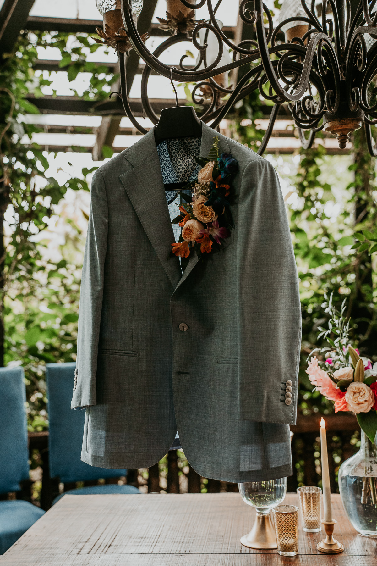 Groom's tailored suit adorned with a boutonniere of fresh flowers, showcasing a touch of elegance and personal style.