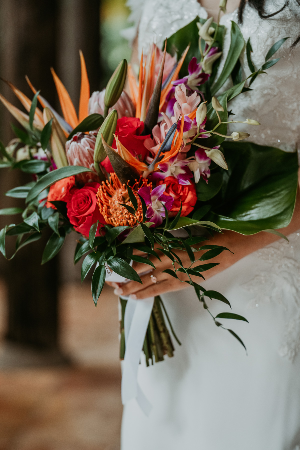 Vibrant bridal bouquet with a mix of tropical flowers and greenery, adding a pop of color to the wedding day