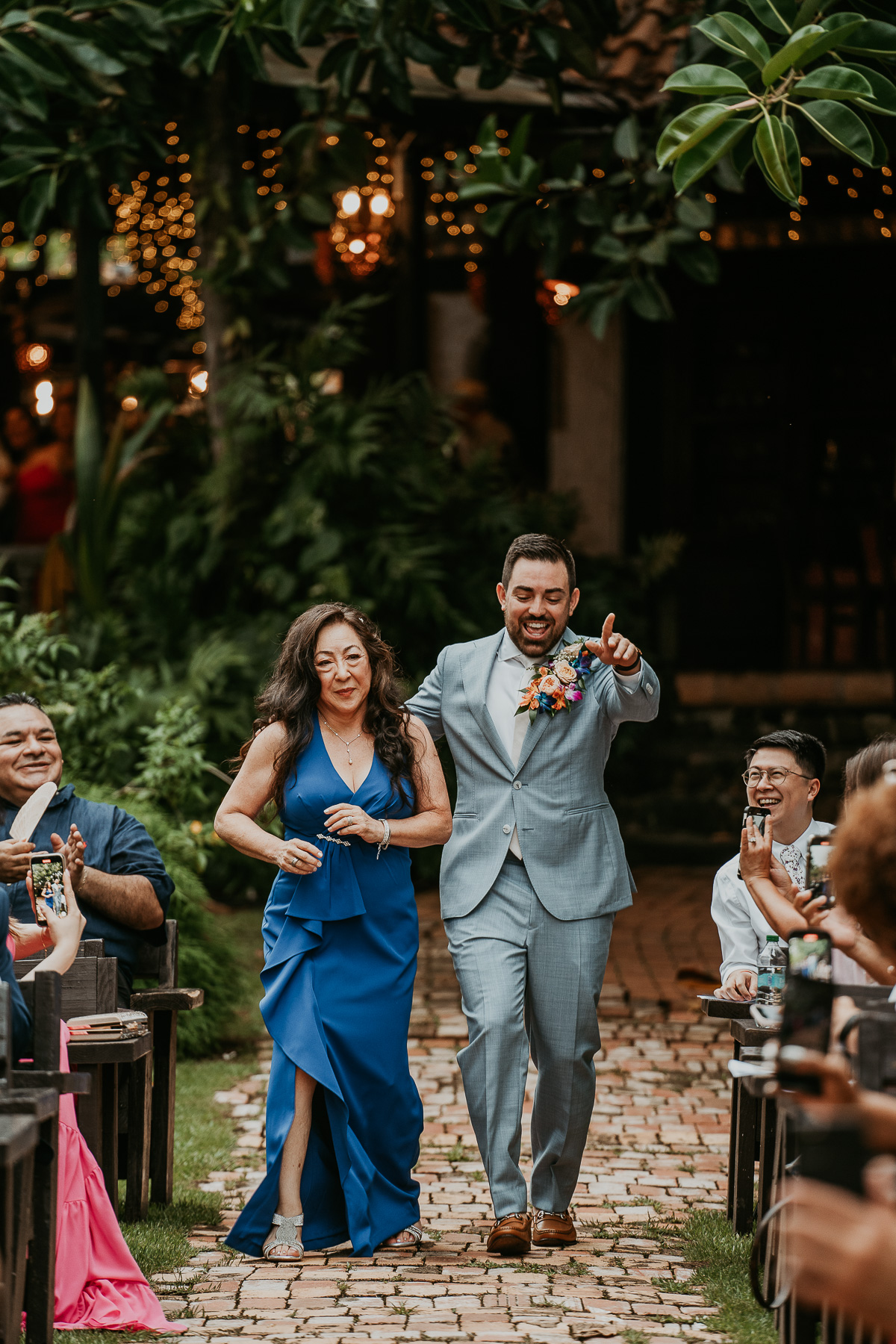 Groom walking with mom to get married at Hacienda Siesta Alegre wedding celebration.