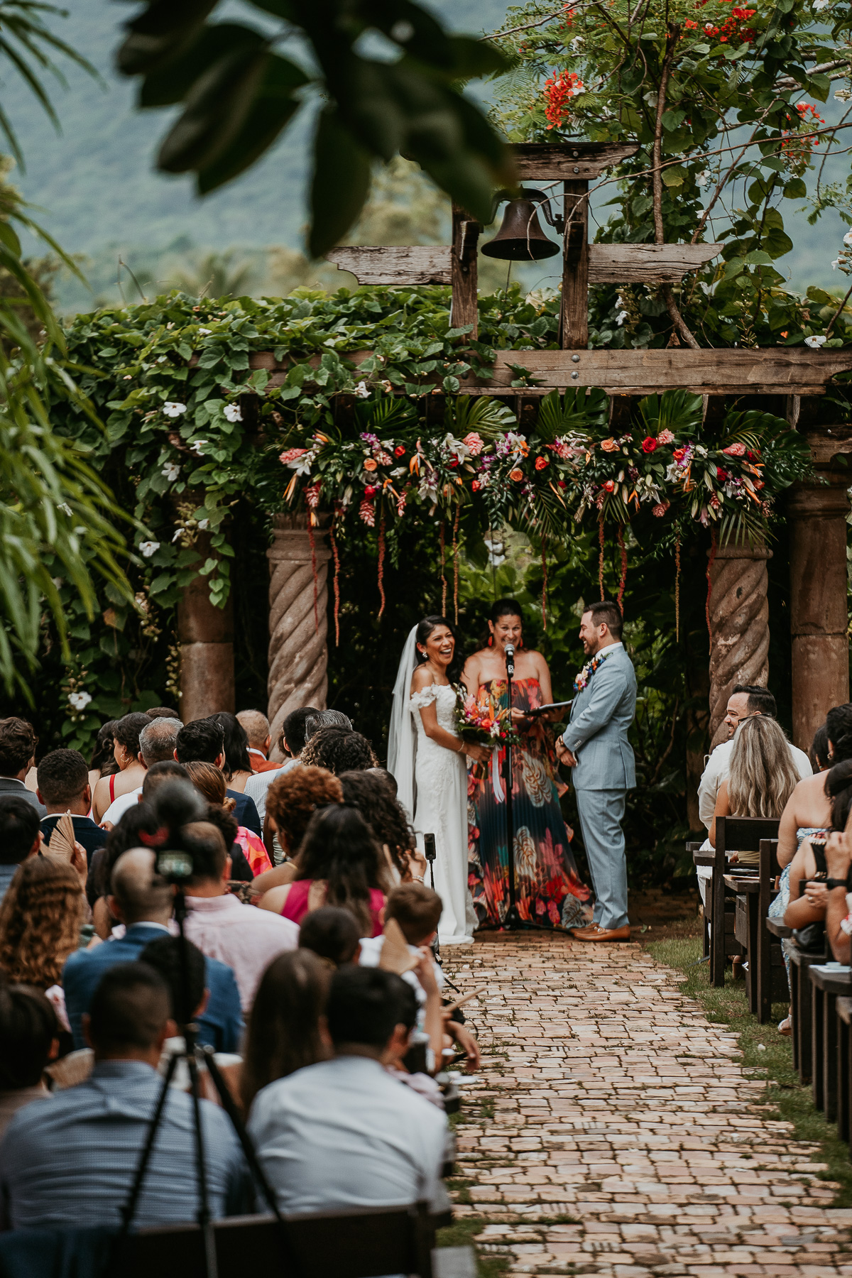 Romantic twilight wedding ceremony at Hacienda Siesta Alegre with guests seated under twinkling lights and lush greenery.