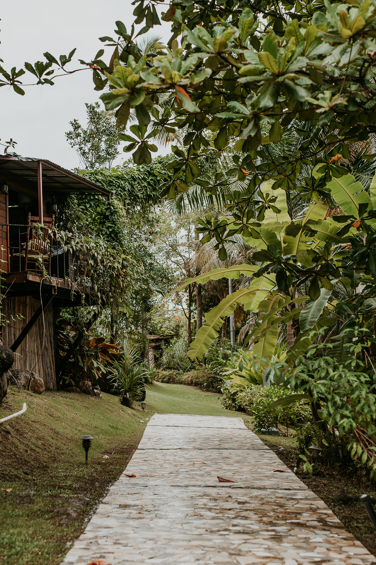 Hacienda Siesta Alegre's enchanting open-air venue with rustic arches, lush tropical foliage, and a view of the surrounding mountains.