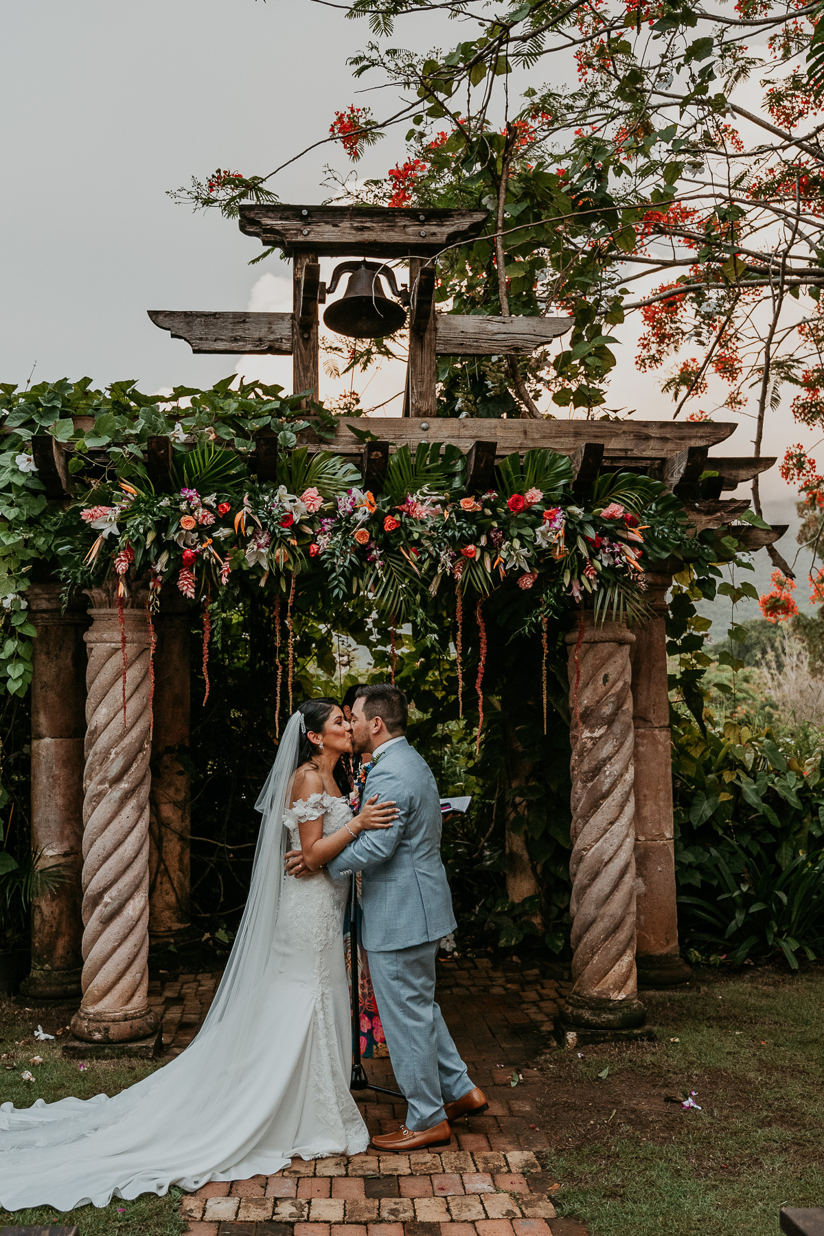 Romantic twilight wedding ceremony at Hacienda Siesta Alegre with guests seated under twinkling lights and lush greenery.