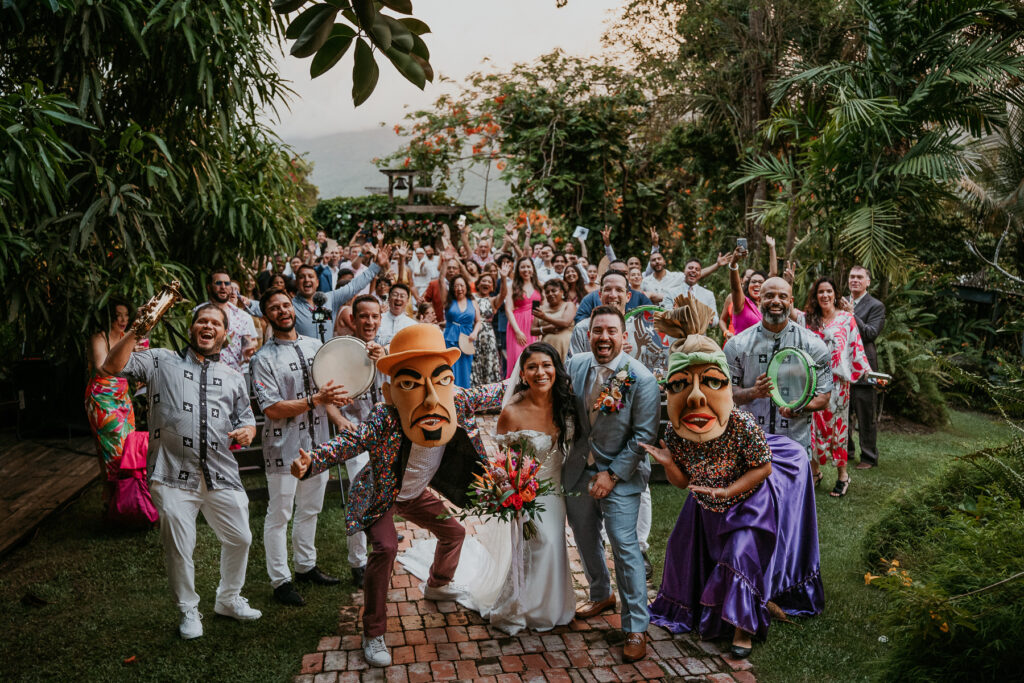 Lively Yuvi Plena musicians leading wedding guests in a vibrant procession with traditional music and dancing.