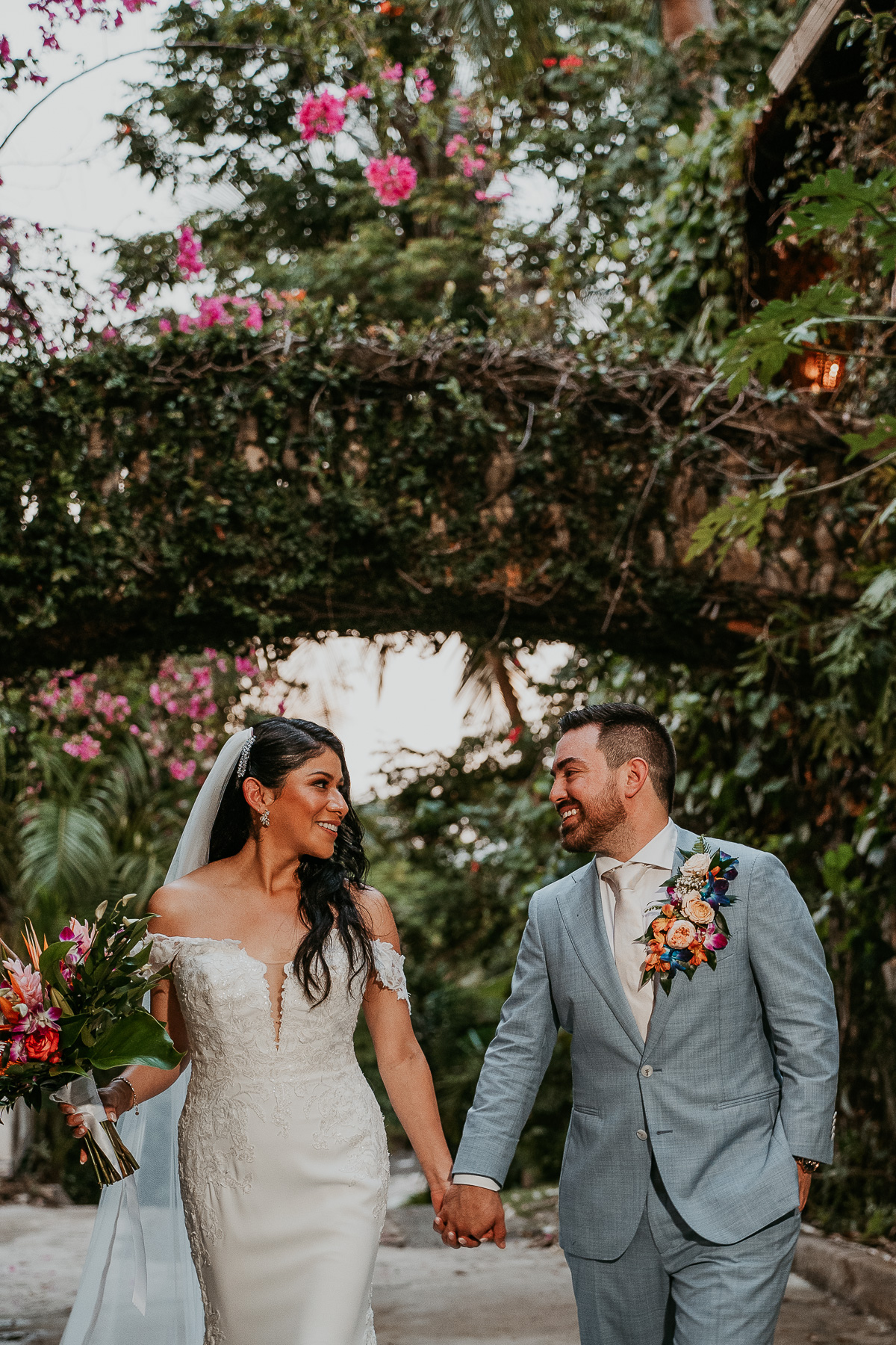 Candid shot of the bride and groom laughing together, capturing their joy and connection on their wedding day.