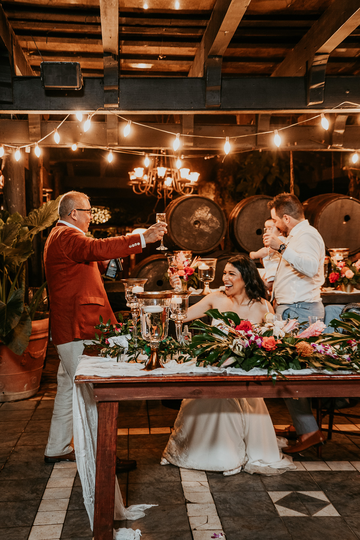 Bride and groom raising their glasses during a heartfelt toast at the reception, surrounded by friends and family at Hacienda Siesta Alegre.