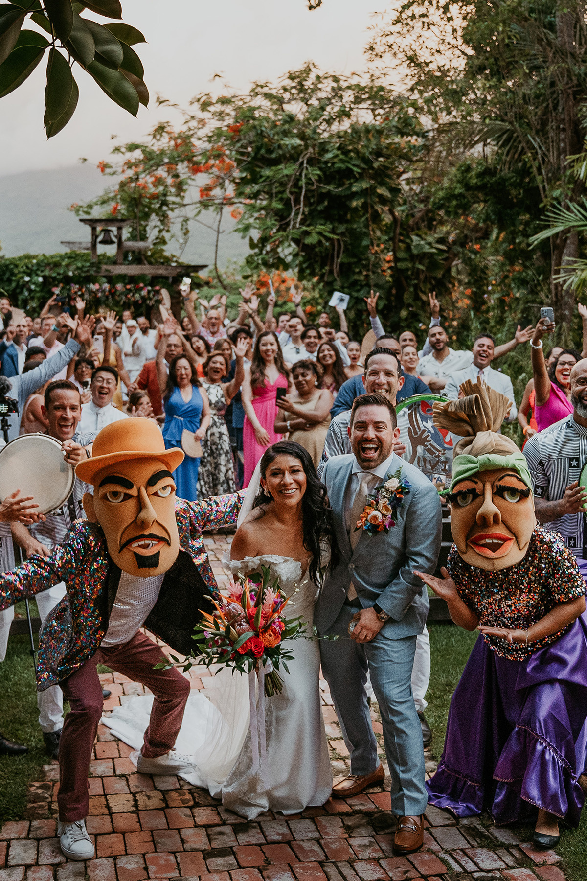 Lively Yuvi Plena musicians leading wedding guests in a vibrant procession with traditional music and dancing.