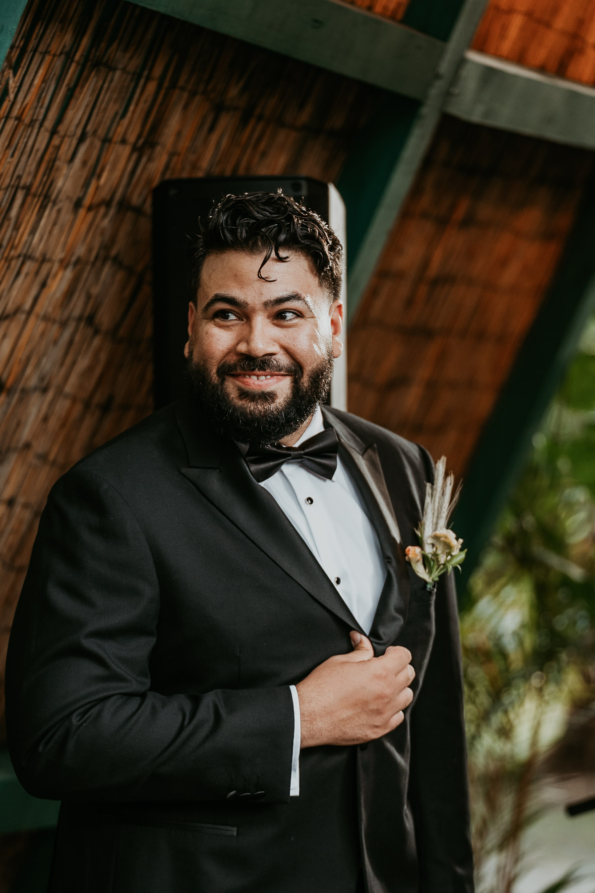 Candid shot of groom's frist look of bride walking down the isle