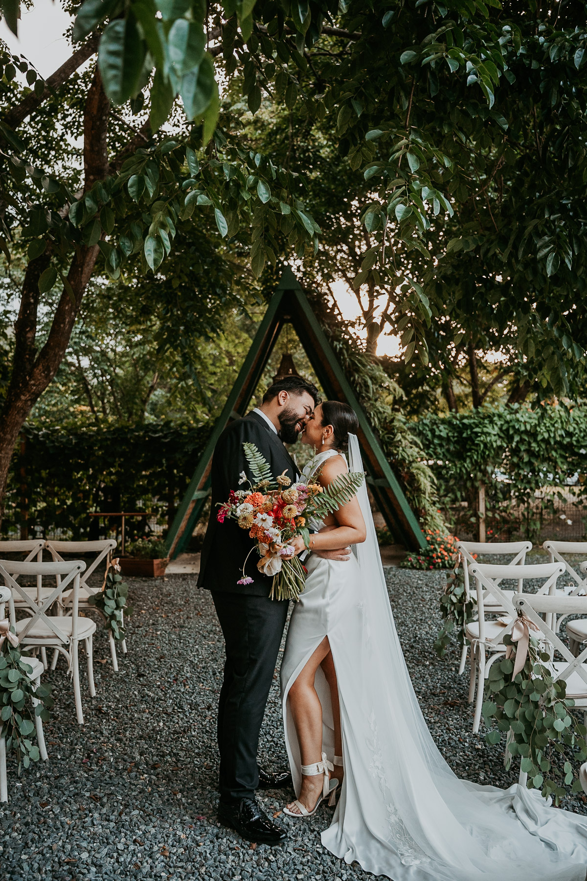 Intimate kiss of newly wed couple at mountain wedding venue Aldeana