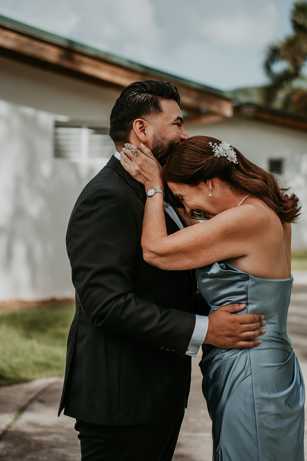 Emotional, candid photo of a groom sharing a quiet, authentic moment with his mother before the ceremony.