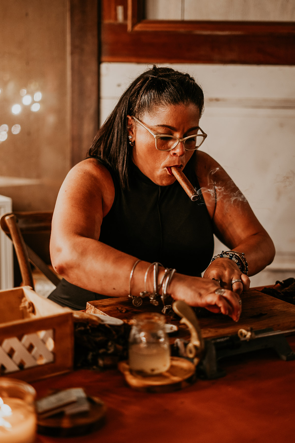 A local torcedor rolling artisanal cigars from La Hoja del Chan during a reception at a Puerto Rico mountain wedding.