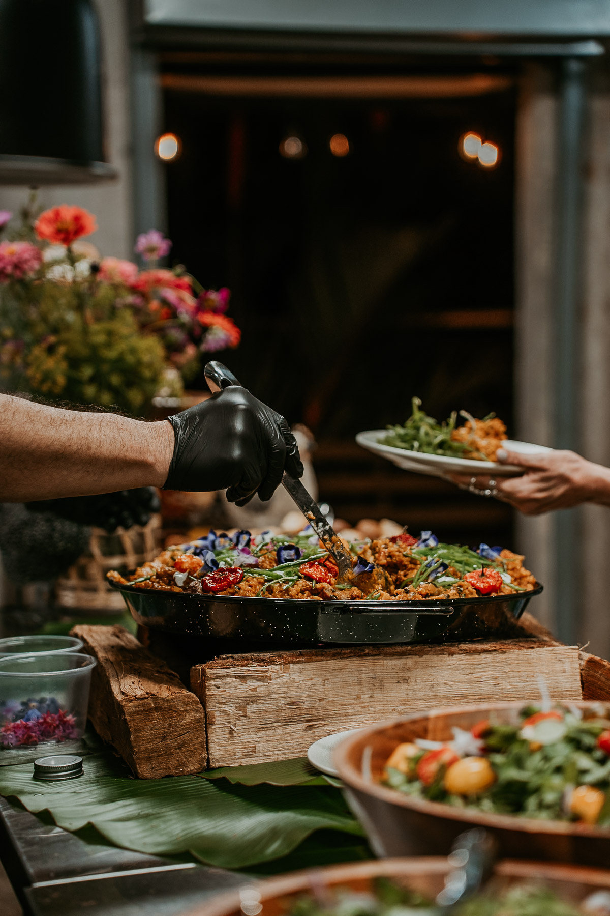 Wedding guests enjoying a custom culinary experience under the open-air wooden bohíos at Aldeana, highlighting authentic island culture.