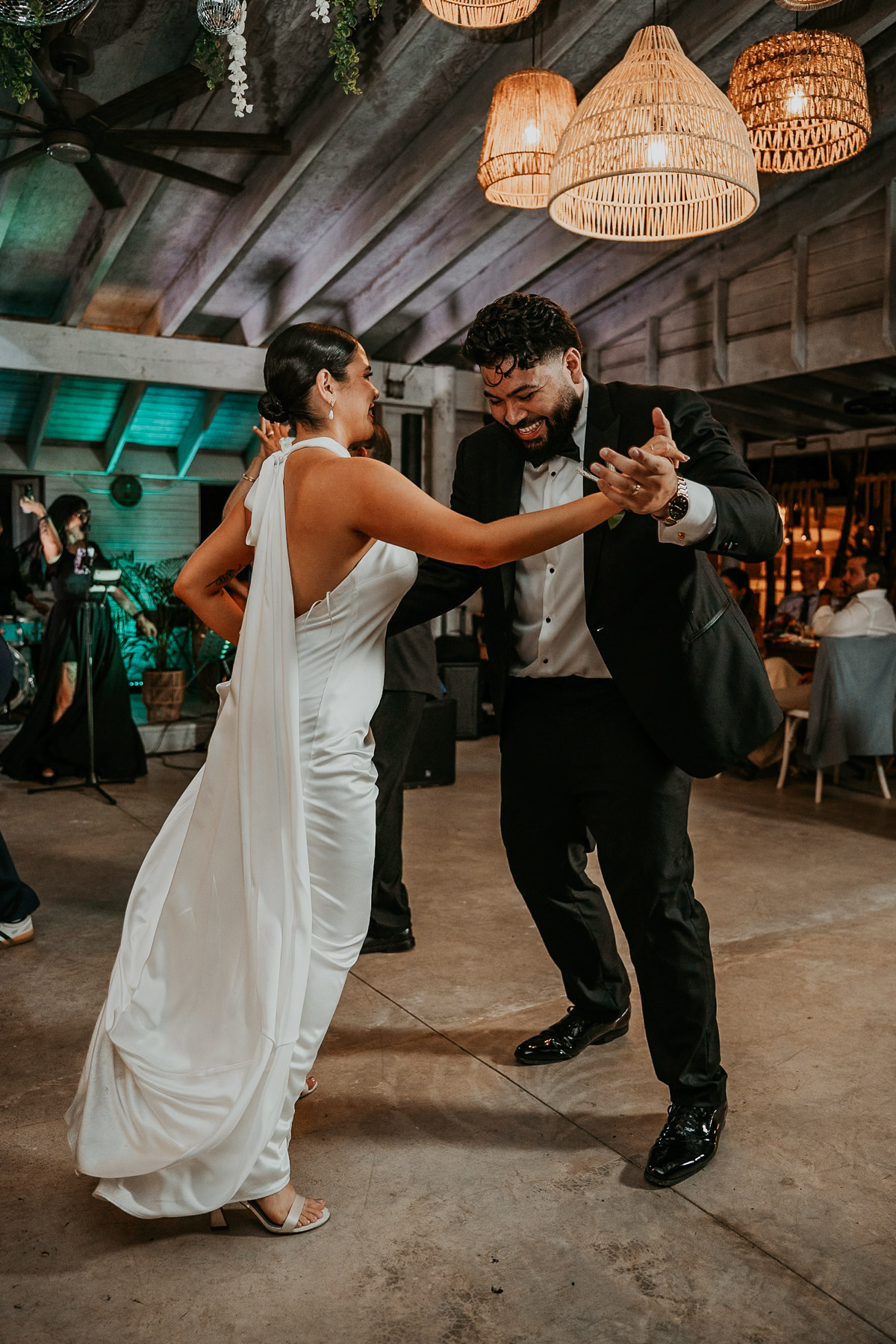 Newlywed couple dancing and celebrating at a small-scale, high-energy alternative wedding celebration in the mountains.