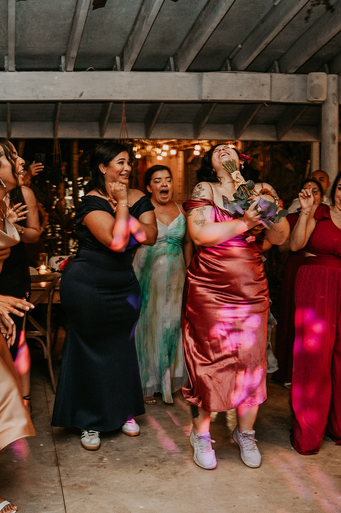 A fun, movement-filled snapshot of the bouquet toss during an intimate wedding reception in Puerto Rico.