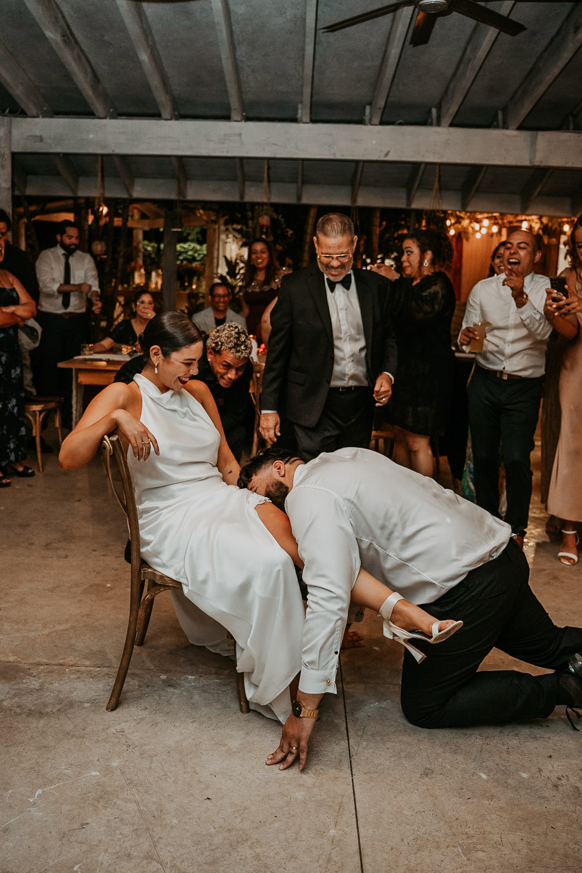 A fun, movement-filled snapshot of the garmet removal during an intimate wedding reception in Puerto Rico.