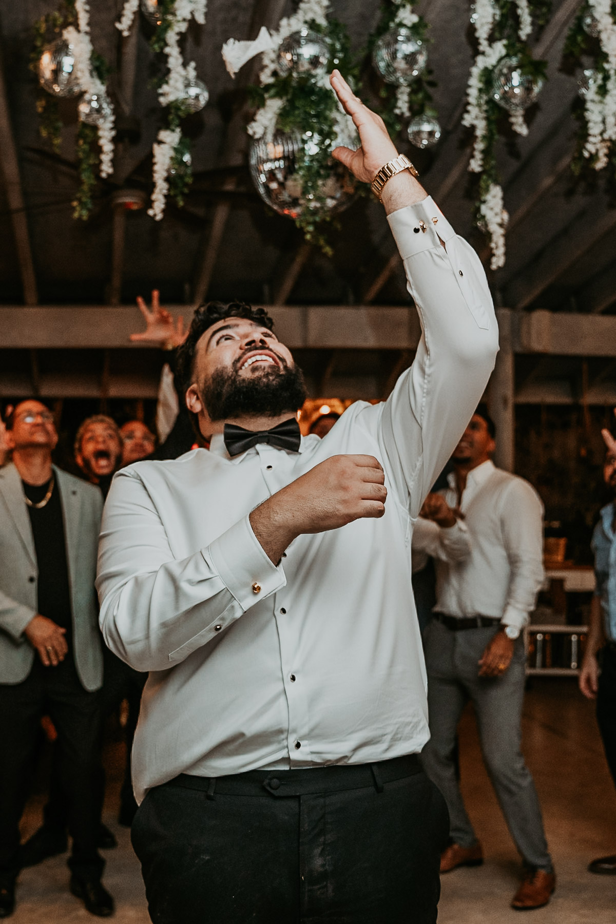 A fun, movement-filled snapshot of the garmet toss during an intimate wedding reception in Puerto Rico.