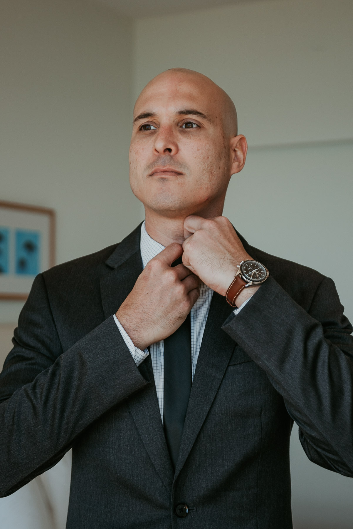 Daniel, the groom, adjusting his tie before the beachfront wedding at La Concha.