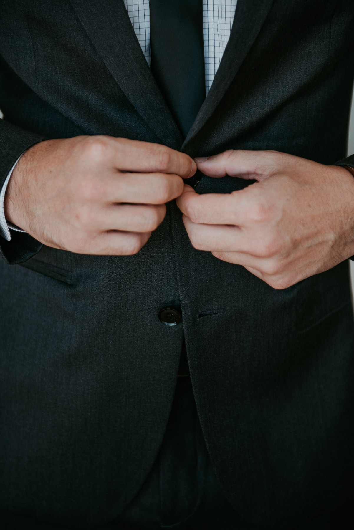 Details shot of groom getting ready.