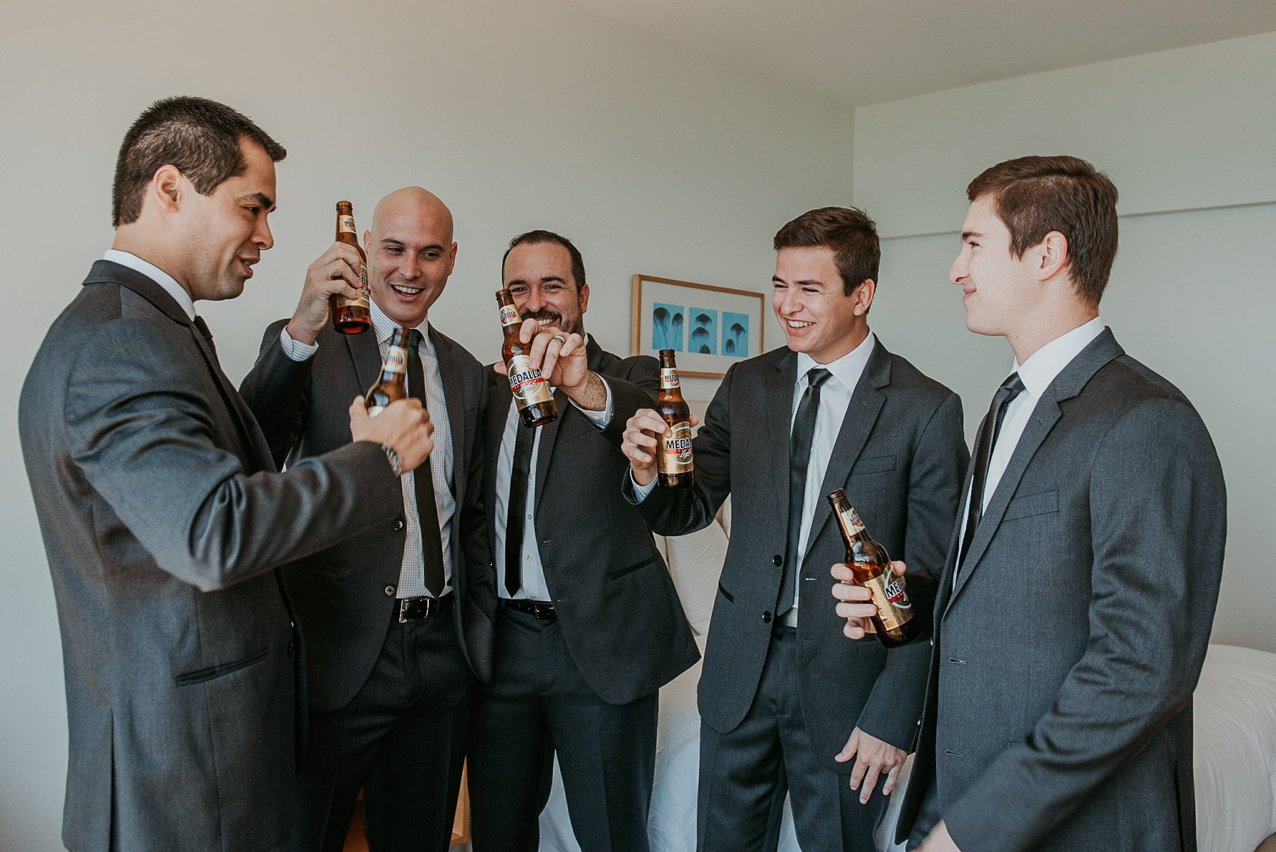 Groomsmen toast with Medalla beer during La Concha Resort Wedding.