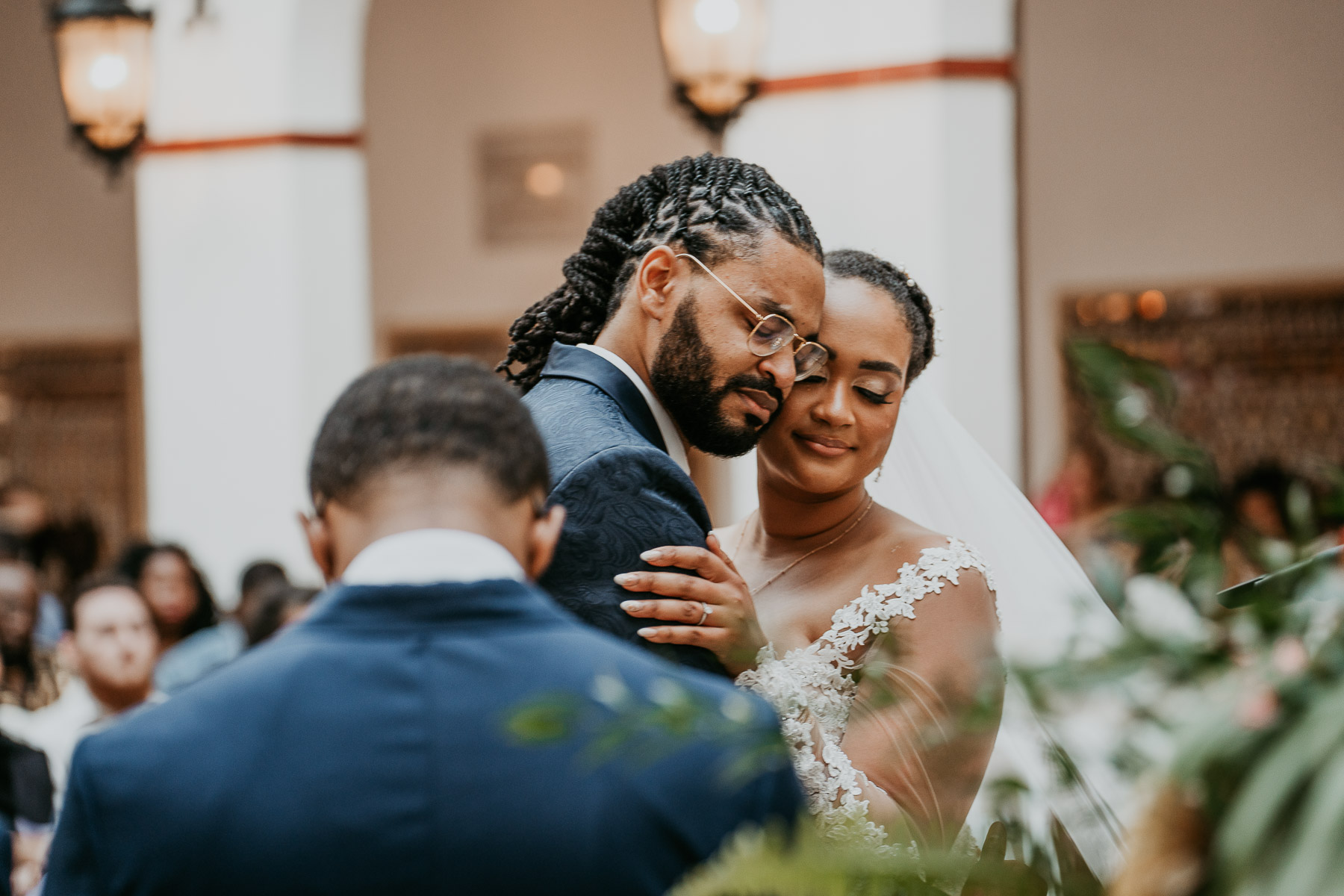 Casa de España Wedding Ceremony: Bride and Groom embracing tenderly