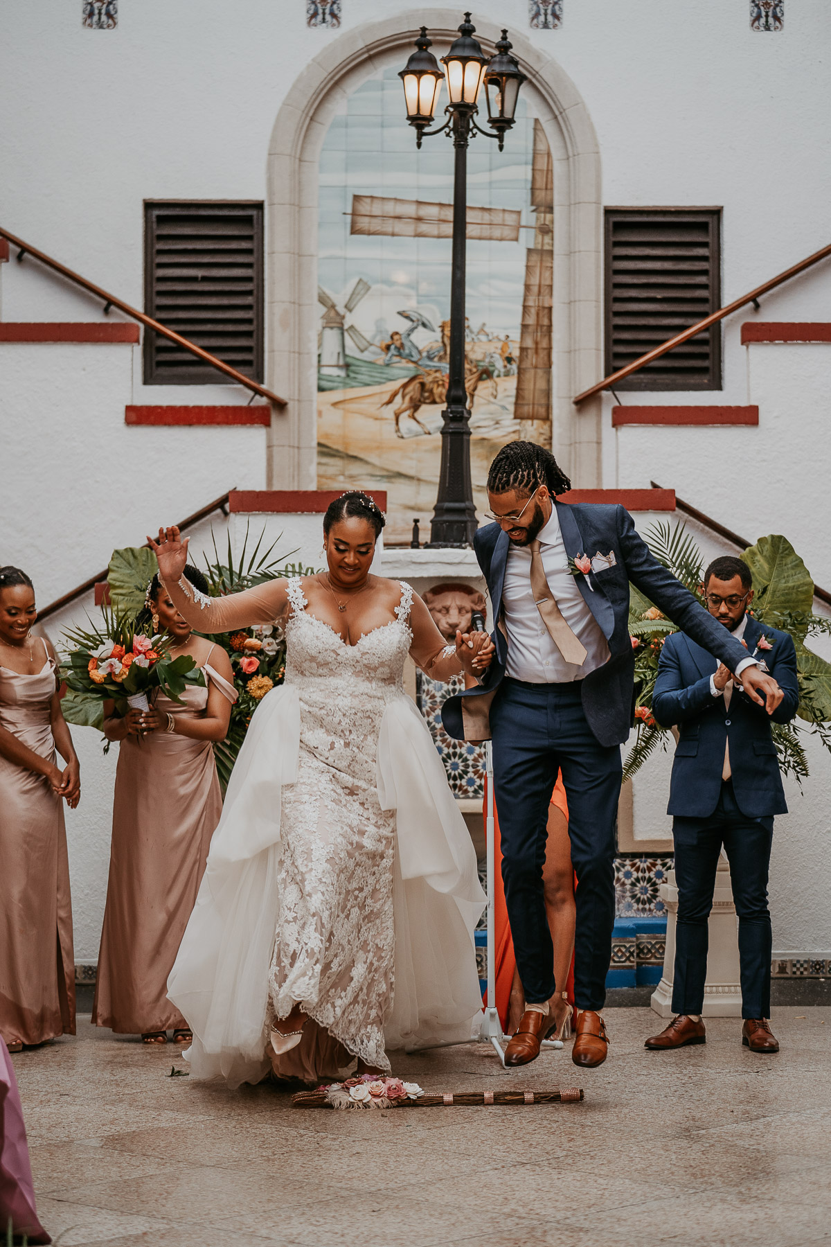 Casa de España Wedding Ceremony: Bride and Groom Jumping the Broom