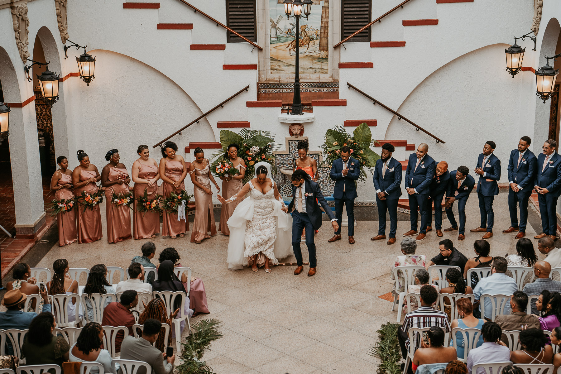 Casa de España Wedding Ceremony: Bride and Groom Jumping the Broom