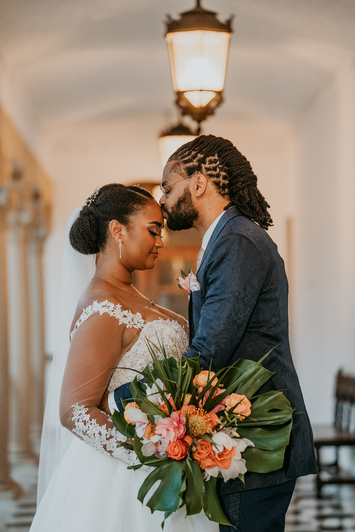 Groom kissing tenderly brides forehead at Casa de España