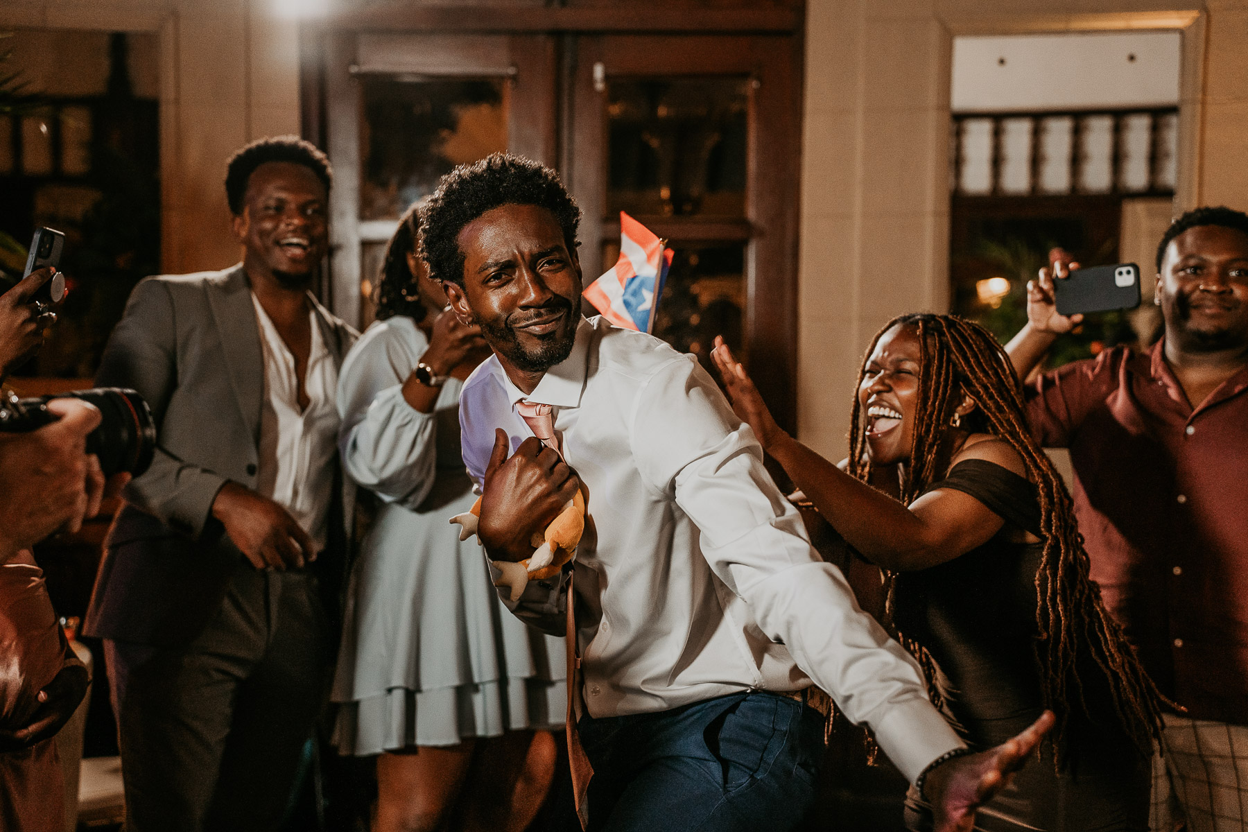 Guest capturing garter at Casa de España wedding.