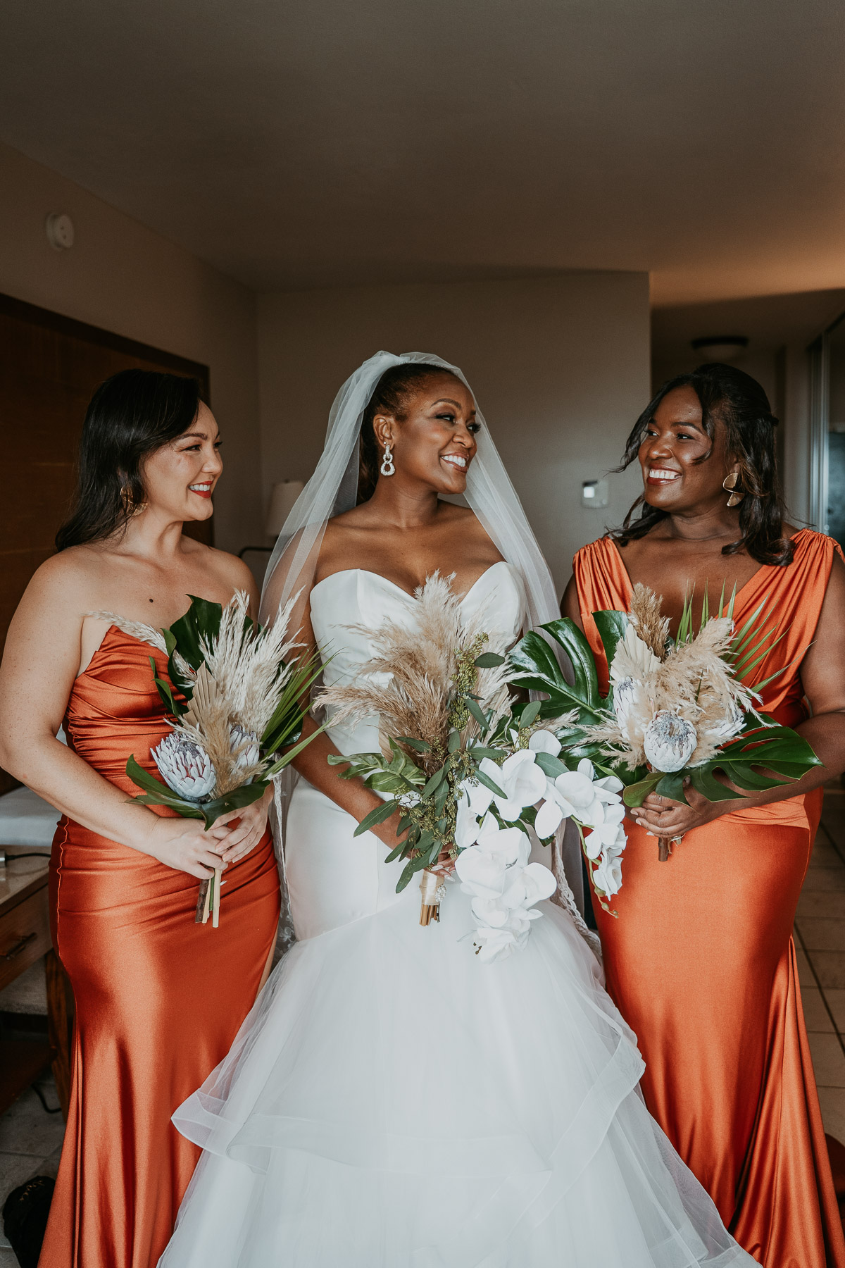 Bride and her bridesmaids sharing a moment together while getting ready for the wedding.