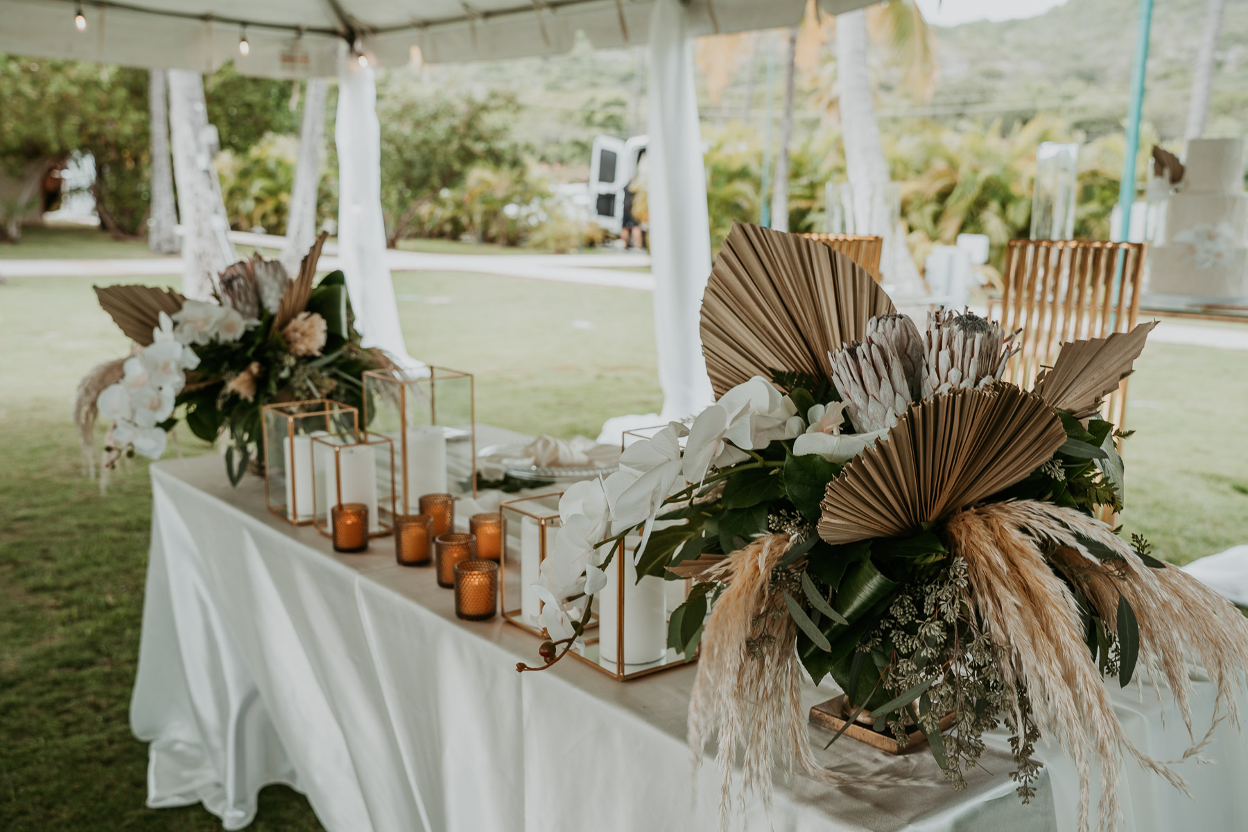 Wedding reception decor featuring tropical flowers and elegant floral arrangements.