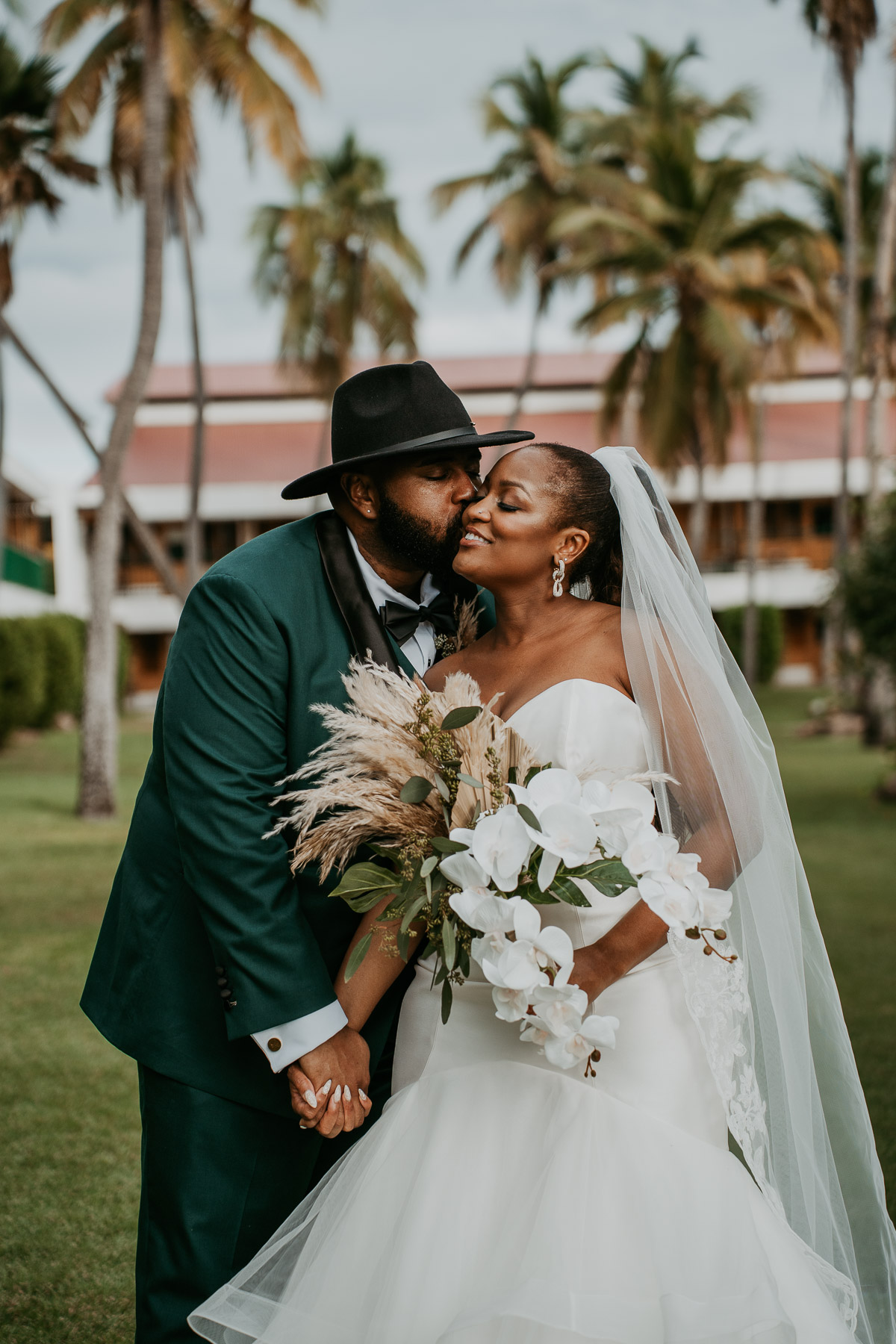 Newlywed couple sharing a quiet moment surrounded by tropical gardens.