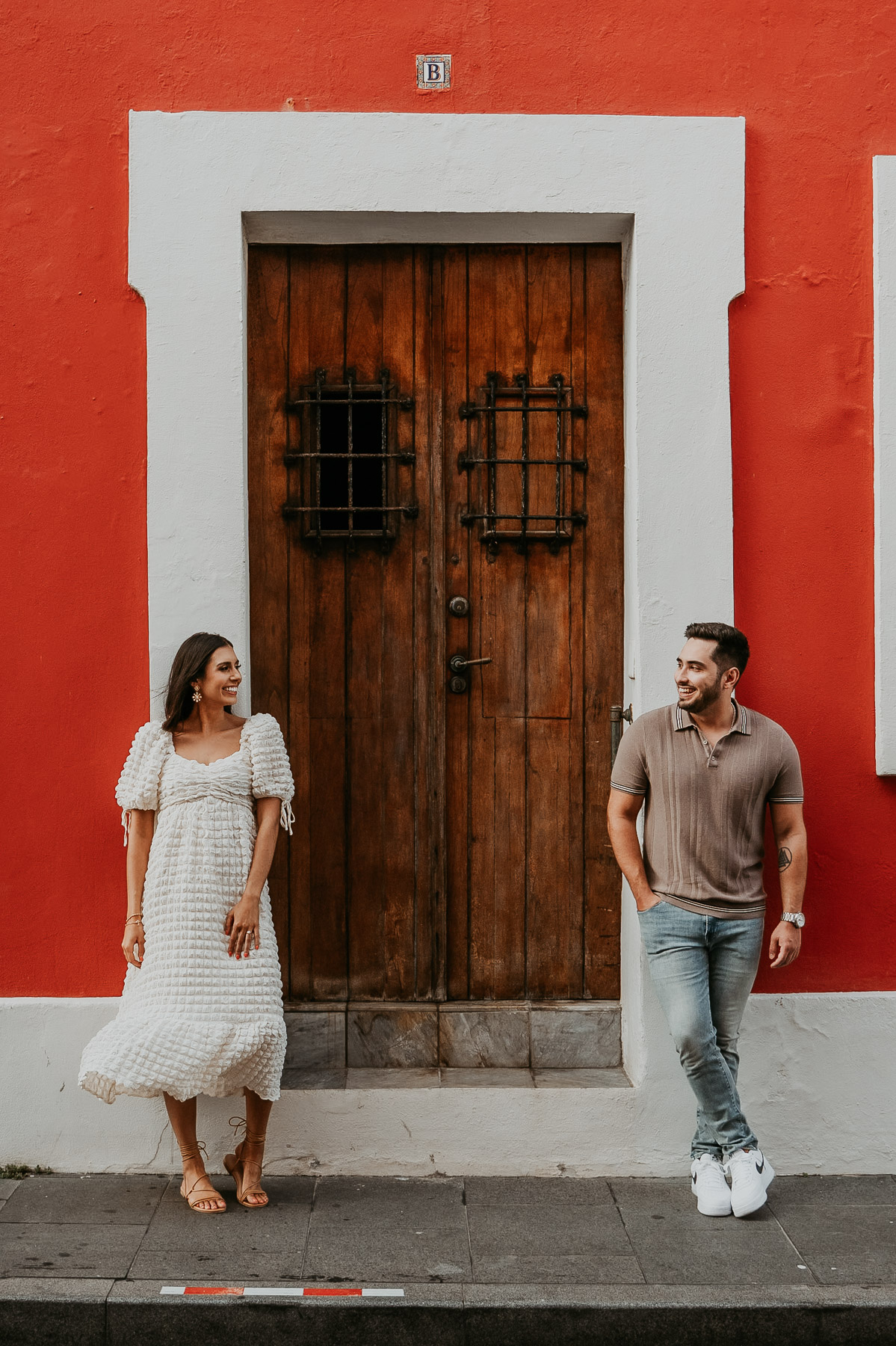 Couple standing in front of a colonial door during photo session.