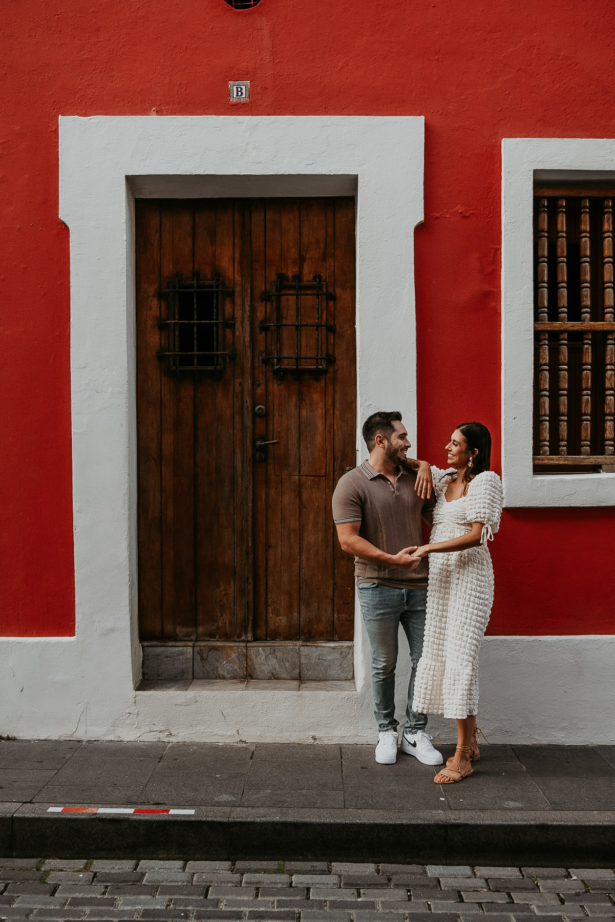 Joyful moment captured near an old wooden door in Puerto Rico’s capital.