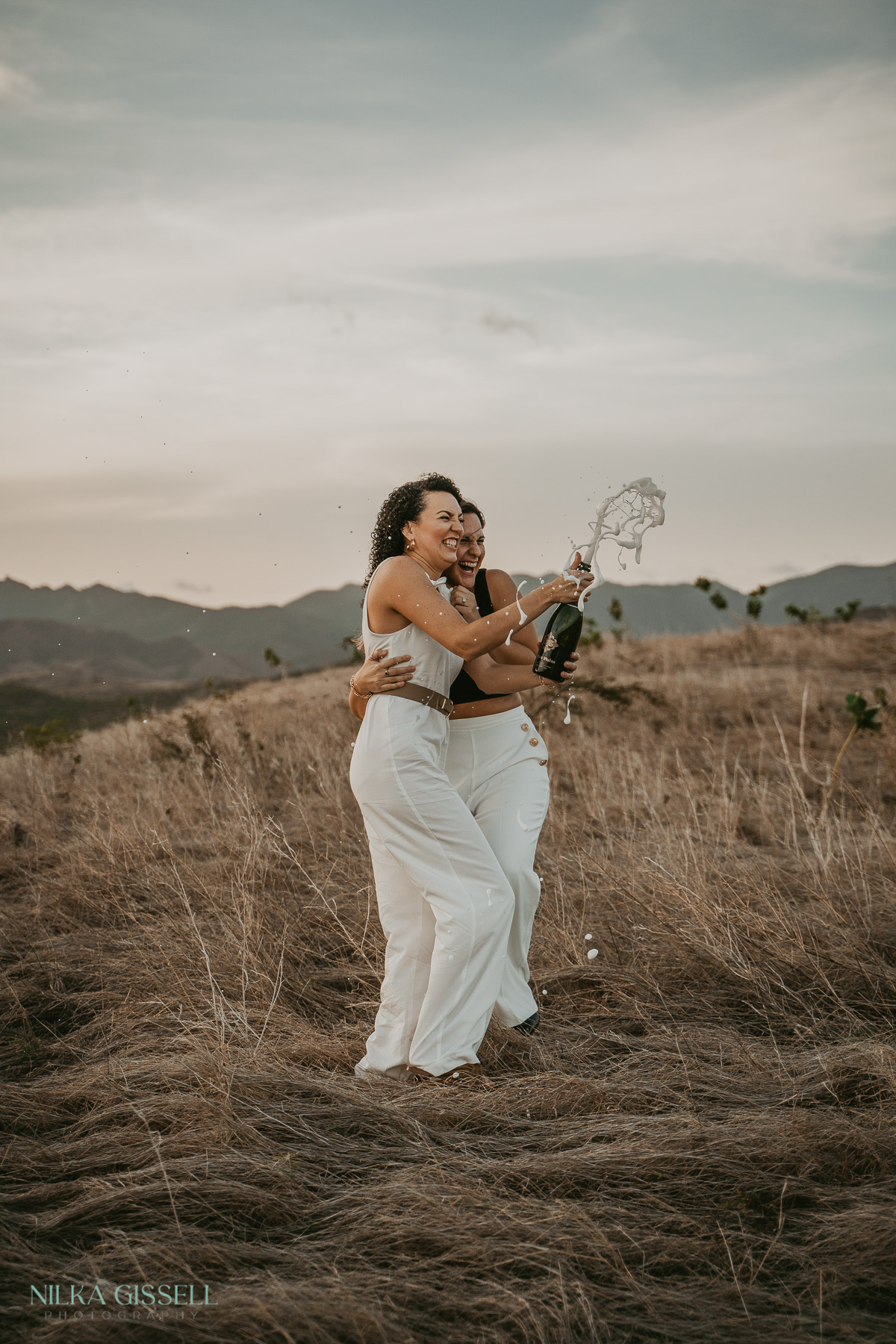 Lesbian couple celebrating their engagement with a photo session at Puerto Rico's mountain range.