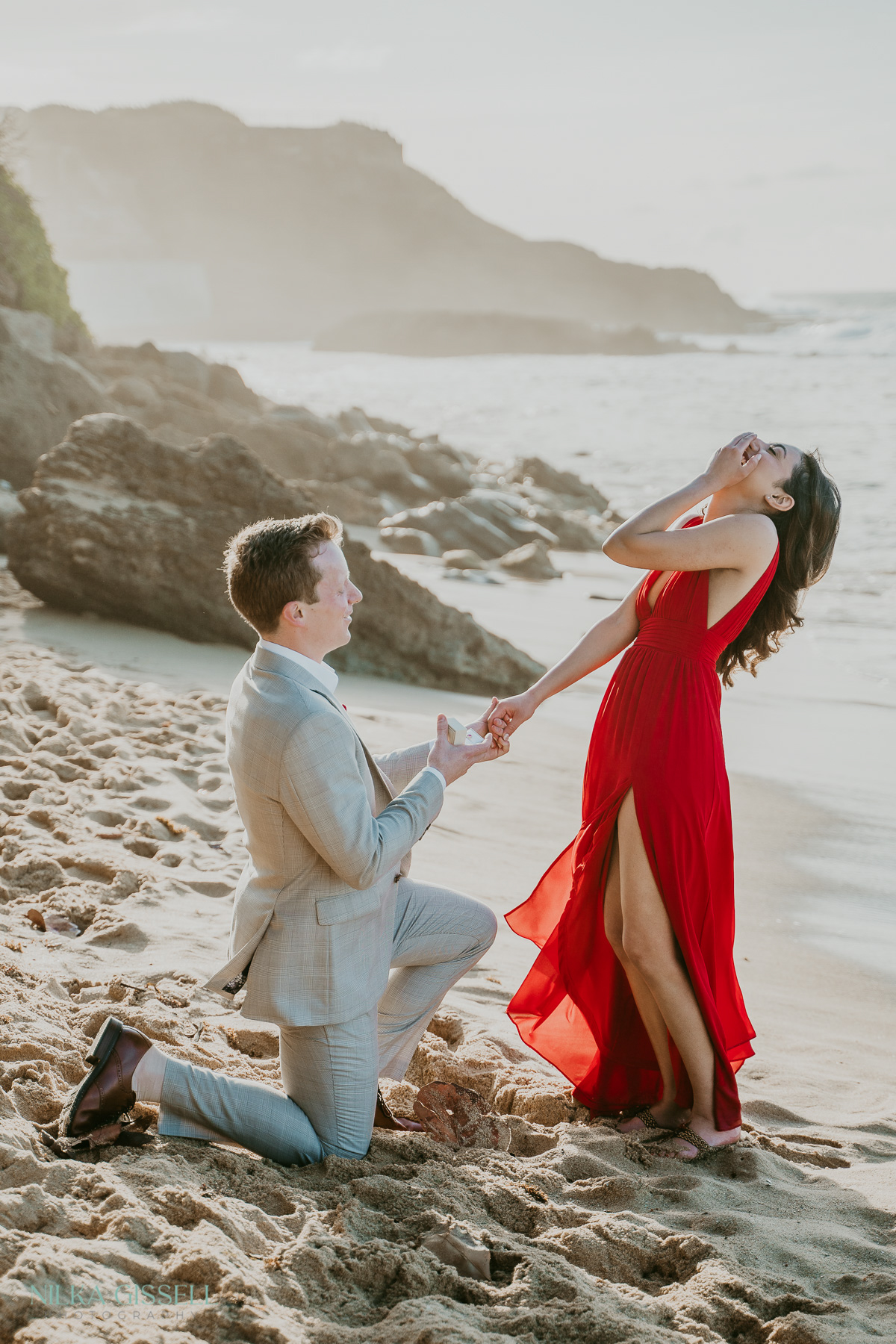 A couple having their proposal captured during a beach stroll in Puerto Rico