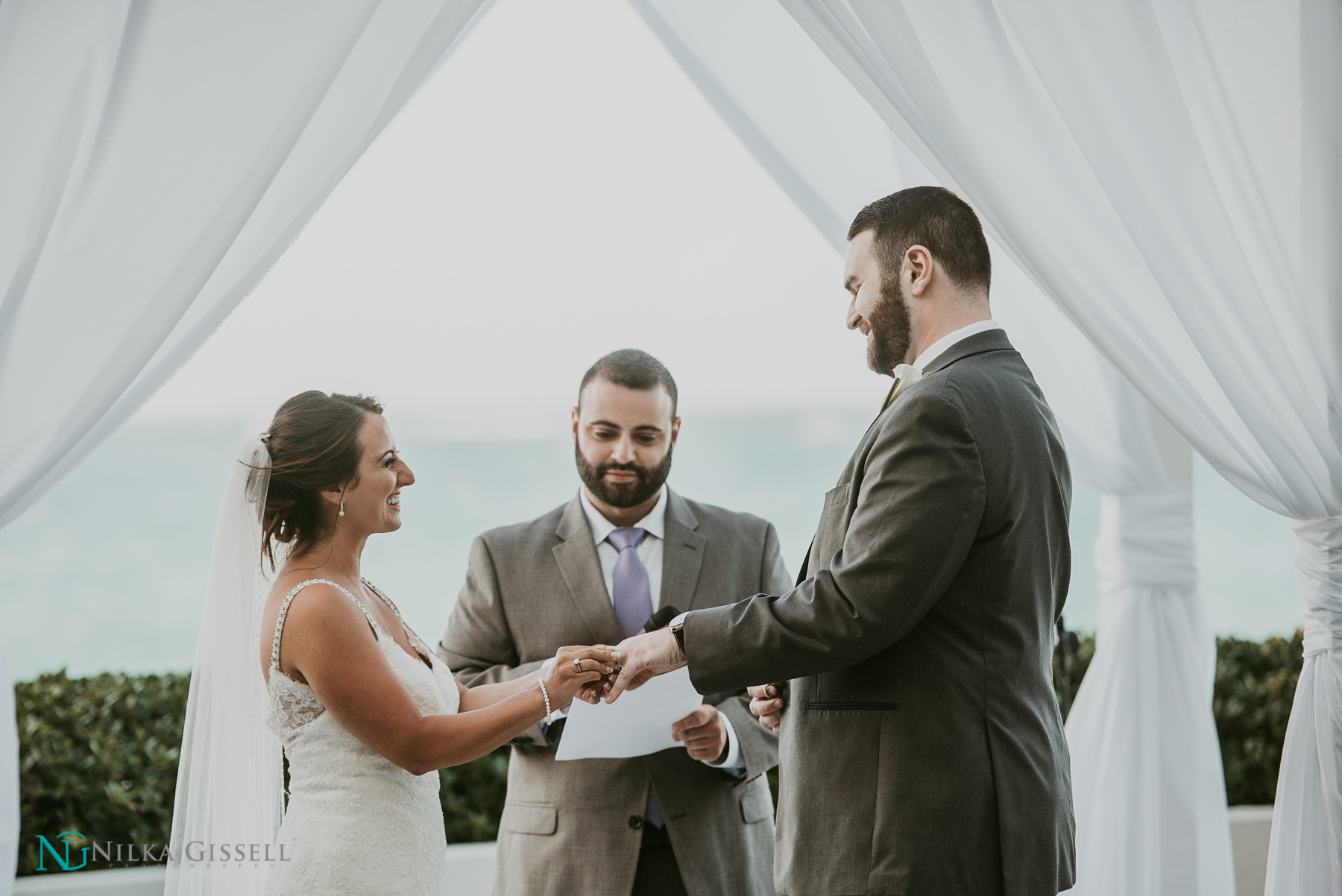 Couple exchanging rings at a Puerto Rico destination wedding.