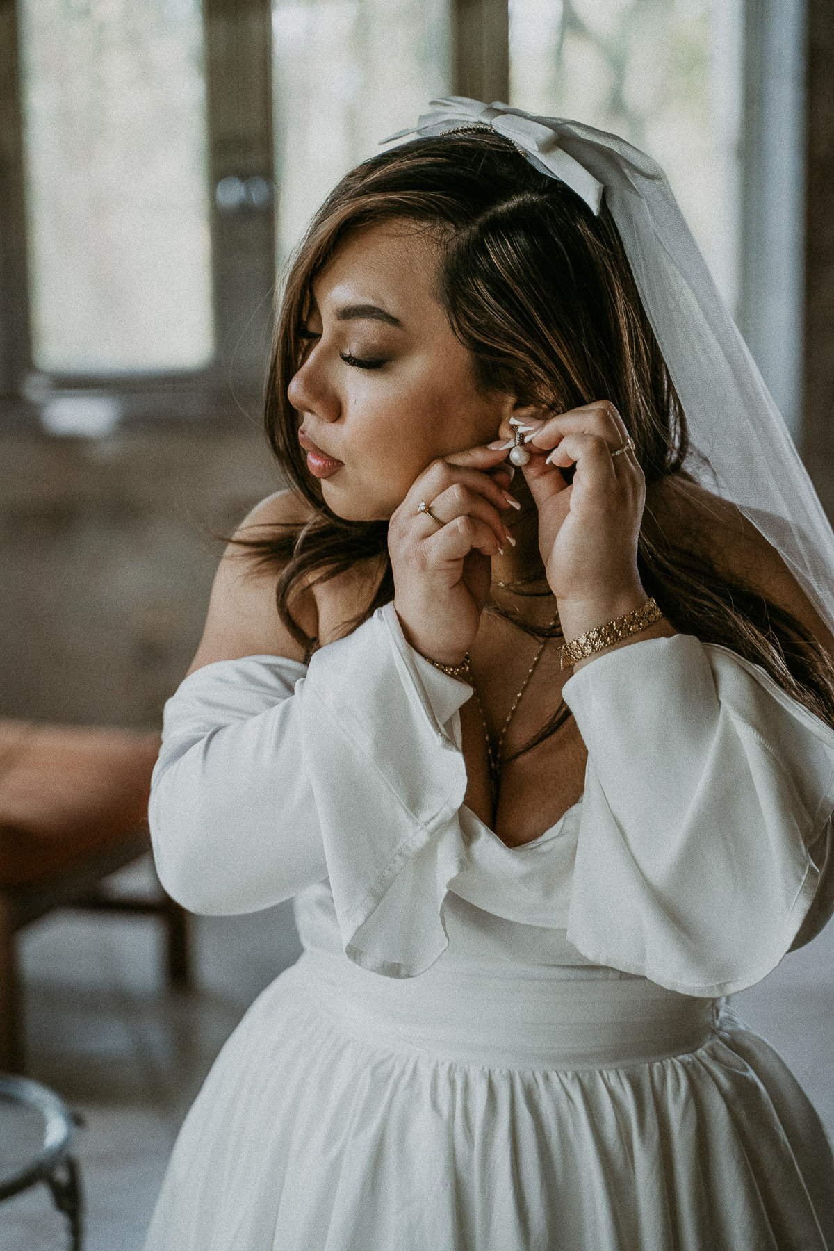 Bride putting on earrings at Dos Aguas Elopement.