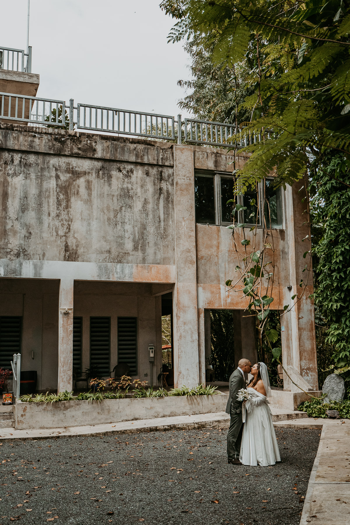 Bride and groom with view of Dos Aguas Boutique Hotel.