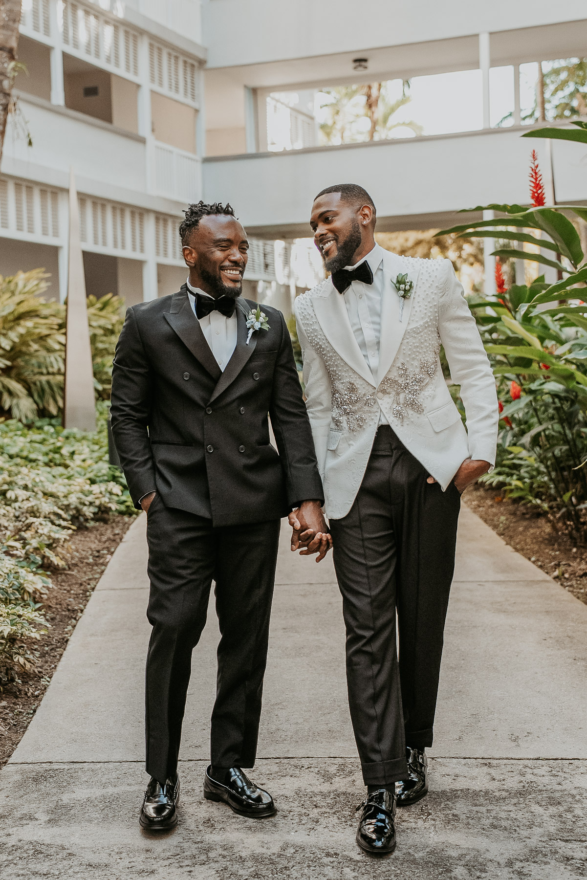 Two grooms standing together on outdoor areas overlooking Fajardo coastline