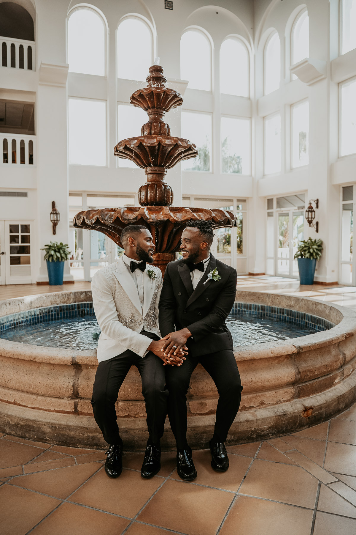 Couple embracing in front of fountain at Puerto Rico wedding venue