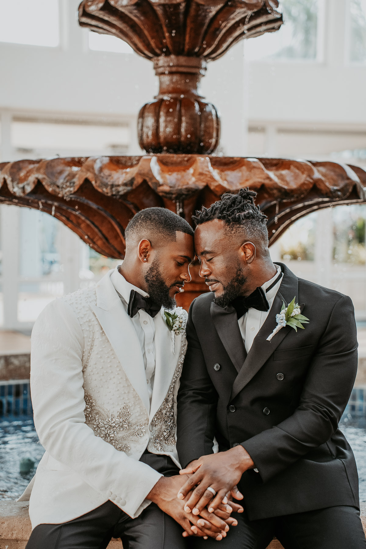 Couple embracing in front of fountain at Puerto Rico wedding venue