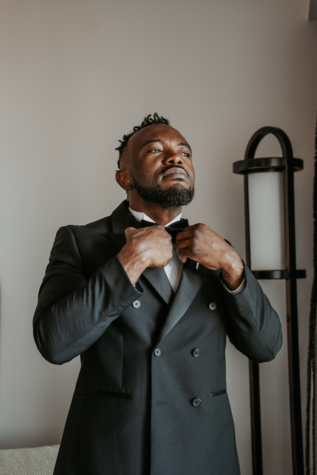 Close up of groom adjusting suit jacket before ceremony in Fajardo Puerto Rico