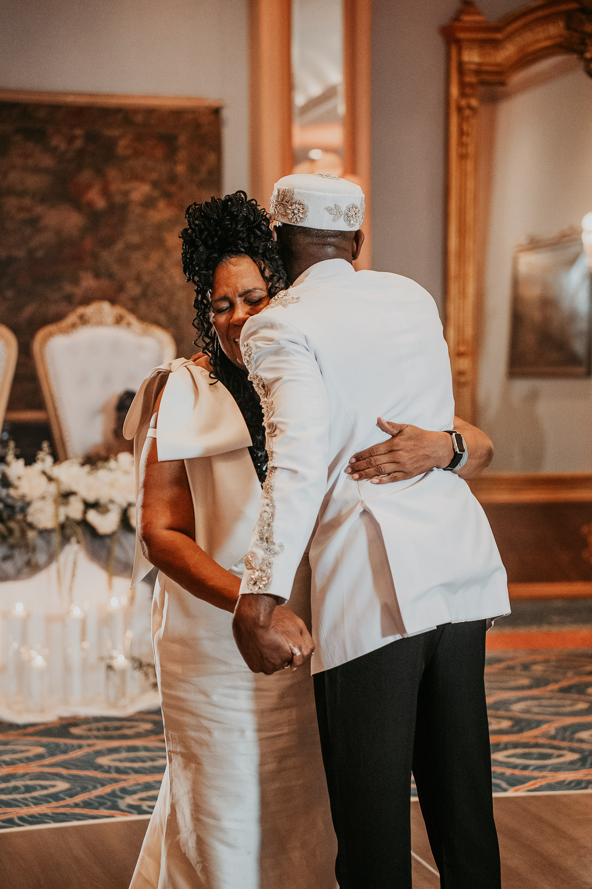 Emotional moment between mother and groom during wedding day celebration