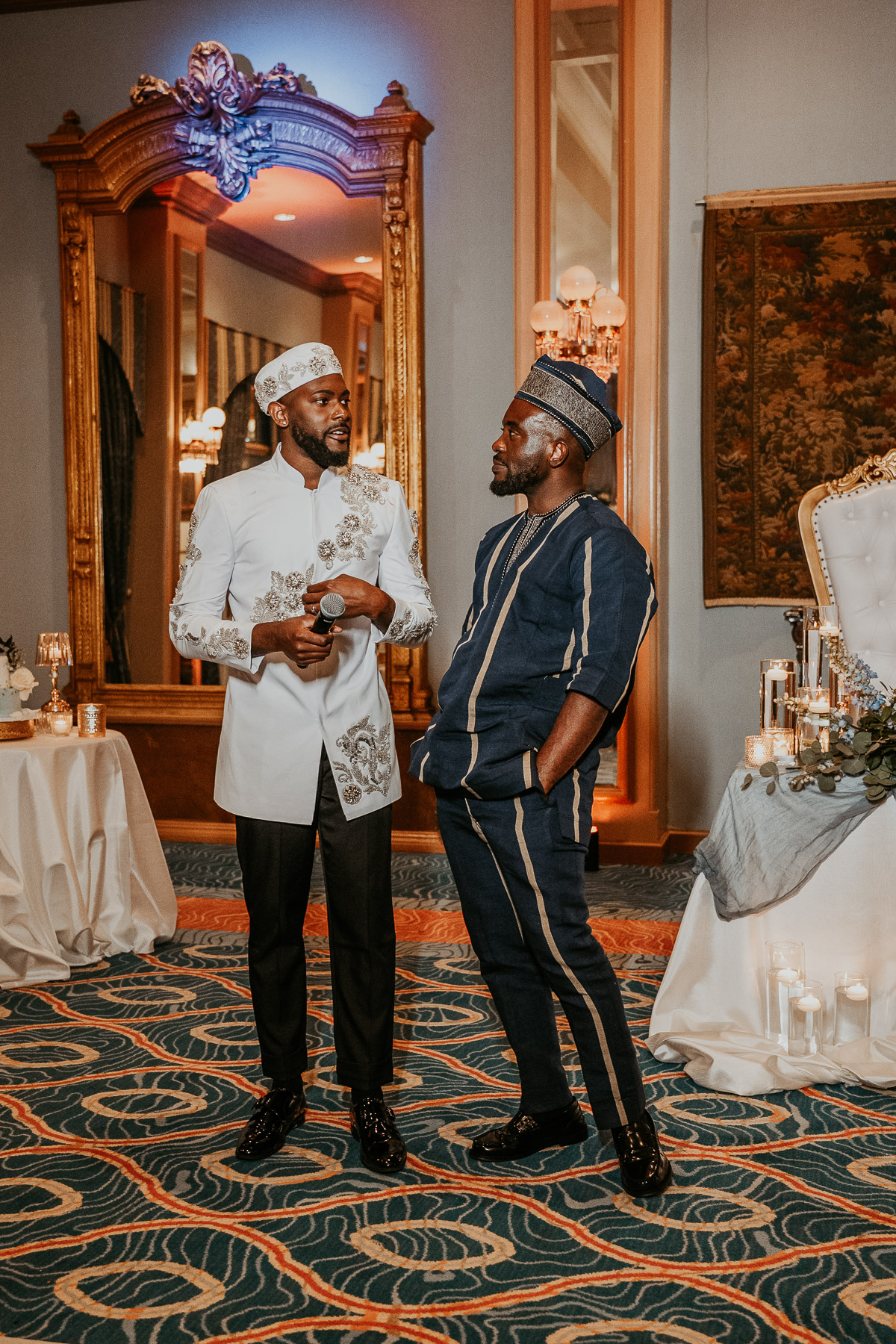 Couple wearing Nigerian Aso Oke outfits during wedding reception celebration