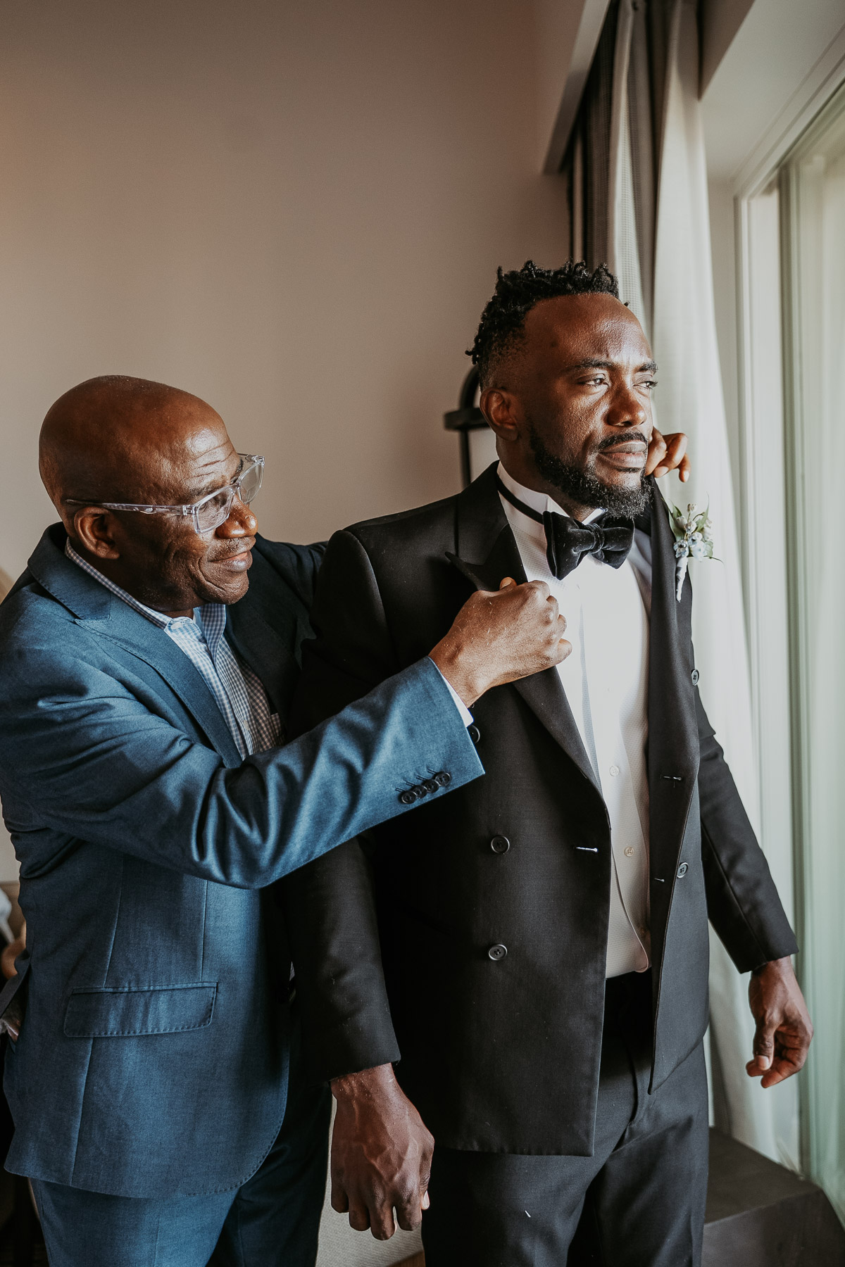 Emotional groom getting ready with family support during Puerto Rico wedding day