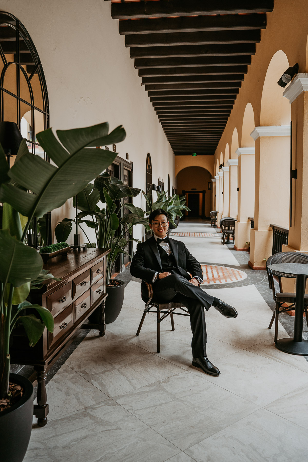 Groom sitting casually at Hotel El Convento