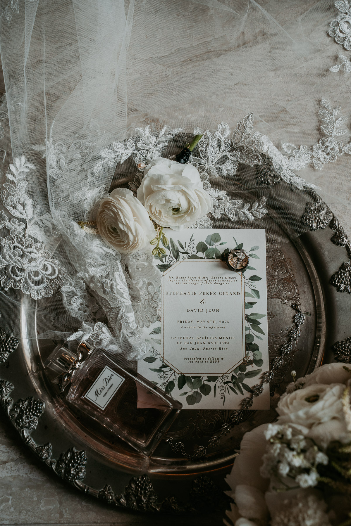Bride details with flowers and invitation over silver platter Hotel El Convento