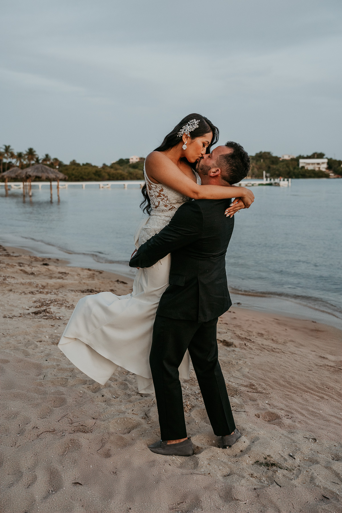 Romantic sunset wedding portraits by the ocean at Copamarina.