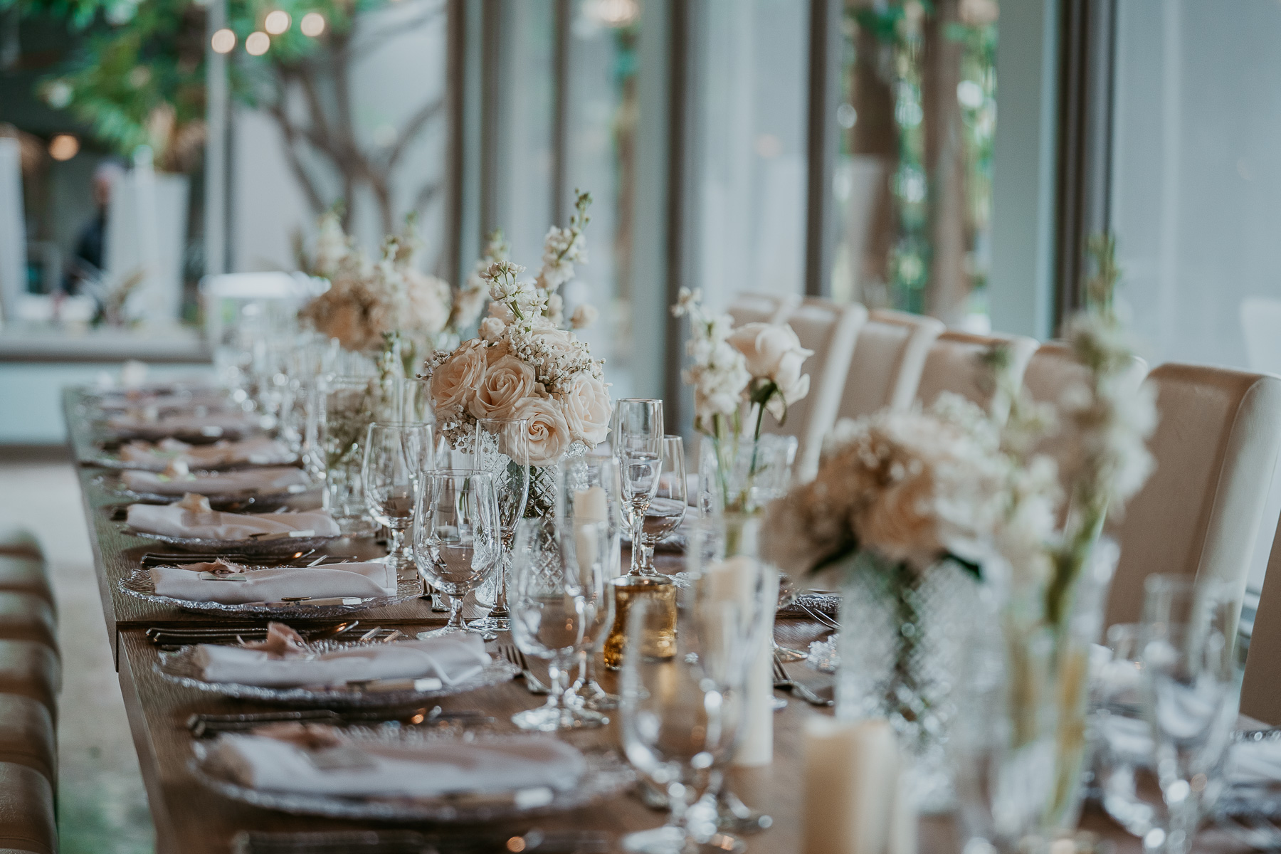 Wedding reception table adorned with white florals at Copamarina Beach Resort.