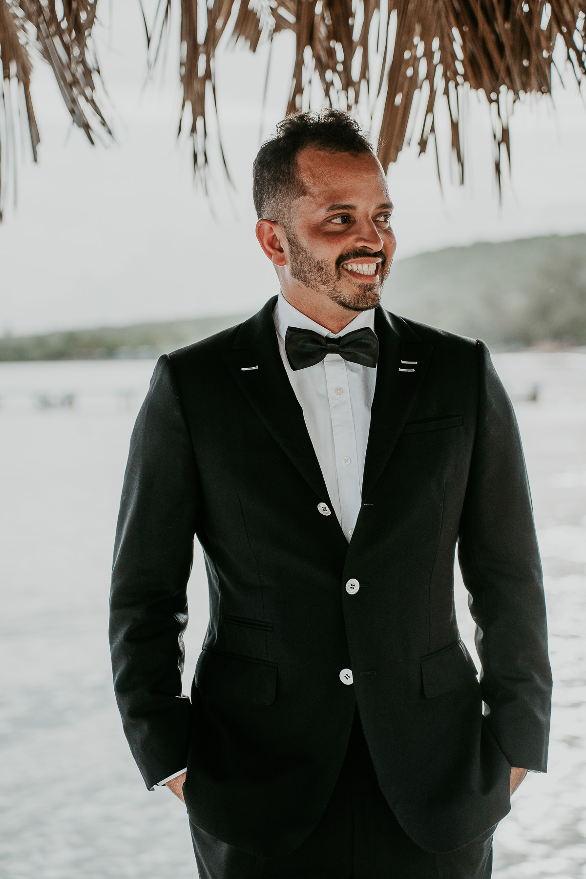 Groom smiling as bride walks down the Isle at Copamarina Beach Resort Wedding.